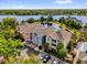 Stunning aerial view of townhomes with a lake and parking at 3344 Corona Village Way # 308, Orlando, FL 32835