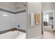 Clean bathroom with a bathtub and shower combination, complemented by neutral-toned tile work at 3344 Corona Village Way # 308, Orlando, FL 32835