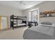 Bright bedroom with a bunk bed, single bed, a desk near a window, and a full length mirror at 3344 Corona Village Way # 308, Orlando, FL 32835