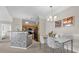 Open dining area featuring a modern table and chair set with a view into the kitchen at 3344 Corona Village Way # 308, Orlando, FL 32835