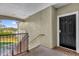 Condo entryway featuring a black front door and a view of the nearby lake at 3344 Corona Village Way # 308, Orlando, FL 32835