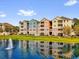 Lovely townhome exterior overlooking a lake with a fountain at 3344 Corona Village Way # 308, Orlando, FL 32835