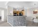 Modern kitchen features wooden cabinetry, stainless steel appliances, and an elegant mosaic-tiled breakfast bar at 3344 Corona Village Way # 308, Orlando, FL 32835