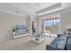 Living room with a view to the screened balcony through a large sliding glass door at 3344 Corona Village Way # 308, Orlando, FL 32835