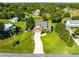 Aerial view of a home with a long driveway and surrounded by green lawns and trees at 3820 Forest Cir, St Cloud, FL 34772
