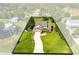 Overhead shot of a beautiful home highlighting its sprawling lot, well-kept lawn, and convenient two-car garage at 3820 Forest Cir, St Cloud, FL 34772