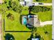 Aerial view of a private backyard featuring a screened-in pool, spacious lawn, and mature trees for added privacy at 3820 Forest Cir, St Cloud, FL 34772