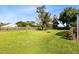 Large grassy backyard with a wooden fence creating a private outdoor space at 3820 Forest Cir, St Cloud, FL 34772