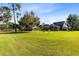 Spacious backyard with a lush lawn and mature trees, offering privacy and room for outdoor activities at 3820 Forest Cir, St Cloud, FL 34772