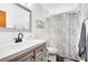 Bathroom featuring a shower/tub combo and vanity with gray cabinets and a decorative shower curtain at 3820 Forest Cir, St Cloud, FL 34772