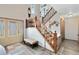 Inviting foyer with a staircase and a stained-glass front door, providing a warm welcome at 3820 Forest Cir, St Cloud, FL 34772
