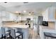 Well-lit kitchen with white cabinets and stainless steel appliances at 3820 Forest Cir, St Cloud, FL 34772