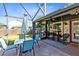 Screened-in patio with an outdoor dining table and a seating area at 3820 Forest Cir, St Cloud, FL 34772