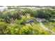 Aerial view of the property showcasing nearby lake and lush surrounding trees at 420 Ketch Rd, St Cloud, FL 34771