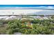 Aerial view of a property surrounded by trees and bordering a lake with a red boundary line at 420 Ketch Rd, St Cloud, FL 34771