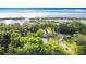 Breathtaking aerial view of two homes surrounded by vibrant greenery and a serene lake backdrop at 420 Ketch Rd, St Cloud, FL 34771