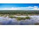 Scenic aerial view of a lake and lush green landscapes under a bright blue sky at 420 Ketch Rd, St Cloud, FL 34771