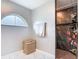 Bathroom featuring shower, a round top window, wicker basket, and shelving at 420 Ketch Rd, St Cloud, FL 34771