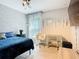 Bedroom featuring a queen size bed, wallpaper, natural light, and modern decor at 420 Ketch Rd, St Cloud, FL 34771