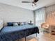 Bedroom featuring a queen size bed, wallpaper, natural light, and modern decor at 420 Ketch Rd, St Cloud, FL 34771