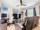 Well-lit room with a comfortable recliner, sleek desk, and organized display shelves at 420 Ketch Rd, St Cloud, FL 34771