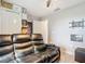 Bonus room with a black leather couch, tv wall mount, and decor at 420 Ketch Rd, St Cloud, FL 34771