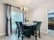 Dining area featuring an elegant chandelier, stylish curtains, and seating for four at 420 Ketch Rd, St Cloud, FL 34771
