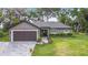 Charming single-story home with a brick driveway, two-car garage, and well-manicured lawn and landscaping at 420 Ketch Rd, St Cloud, FL 34771
