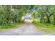 Charming single-story home with a well-maintained lawn, driveway, and abundant trees and lush landscaping at 420 Ketch Rd, St Cloud, FL 34771