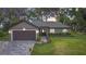 Charming single-story home with a brick driveway, two-car garage, and well-manicured lawn and landscaping at 420 Ketch Rd, St Cloud, FL 34771