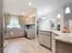 Stylish kitchen featuring gray cabinetry, stainless steel appliances, mosaic backsplash, and wood-look tile flooring at 420 Ketch Rd, St Cloud, FL 34771