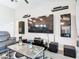 Living room with sleek furniture, a large-screen TV, and modern decor at 420 Ketch Rd, St Cloud, FL 34771