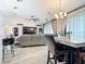 View of the open-concept living room and kitchen area with a gray sofa and kitchen island at 420 Ketch Rd, St Cloud, FL 34771