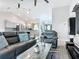 Living room with sleek furniture, a view of the kitchen, and modern decor at 420 Ketch Rd, St Cloud, FL 34771