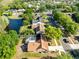 Aerial shot of a property featuring a screened pool, complemented by a serene pond and lush neighborhood surroundings at 4216 Gold Rush Ln, St Cloud, FL 34772