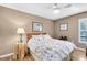 Comfortable bedroom with wood laminate flooring, a ceiling fan, and bright natural light at 4216 Gold Rush Ln, St Cloud, FL 34772