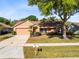 Inviting home features a manicured lawn, two-car garage, and tasteful landscaping for curb appeal at 4216 Gold Rush Ln, St Cloud, FL 34772