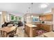 Open-concept kitchen with light wood cabinetry and tiled flooring, flowing into the adjacent living space at 4216 Gold Rush Ln, St Cloud, FL 34772