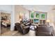 Comfortable living room featuring plush leather seating, a ceiling fan and a built-in media center with bright natural light at 4216 Gold Rush Ln, St Cloud, FL 34772