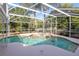 Screened-in pool with a spa and tropical landscaping at 4216 Gold Rush Ln, St Cloud, FL 34772