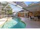 An angle showcasing the hot tub attached to the in ground screened pool and outdoor seating at 4216 Gold Rush Ln, St Cloud, FL 34772