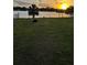 Spacious backyard with views of the lake, palm trees and beautiful sunset at 4343 Lake Richmond Dr, Orlando, FL 32811