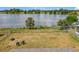 A large, fenced backyard with a scenic lake view, ideal for enjoying nature and outdoor living at 4343 Lake Richmond Dr, Orlando, FL 32811