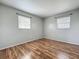This is a simple bedroom with wood floors and two windows at 4343 Lake Richmond Dr, Orlando, FL 32811