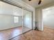 Bright bedroom with tile flooring, a sliding door closet, and neutral walls at 4343 Lake Richmond Dr, Orlando, FL 32811