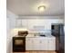 Functional kitchen with white cabinets, modern appliances, and ample counter space at 4343 Lake Richmond Dr, Orlando, FL 32811