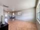 Bright living room with neutral walls, tile flooring, and a sliding glass door to a patio at 4343 Lake Richmond Dr, Orlando, FL 32811