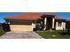 Inviting single-story home featuring a barrel tile roof and a brick paver driveway at 448 Cinnamon Dr, Kissimmee, FL 34759