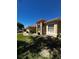 Charming single-story home with a well-manicured lawn, beautiful landscaping, and a terracotta tile roof at 448 Cinnamon Dr, Kissimmee, FL 34759