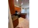 Modern kitchen featuring granite countertops, wood cabinets, and stainless steel appliances at 448 Cinnamon Dr, Kissimmee, FL 34759